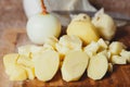 Peeled potatoes diced on cutting board